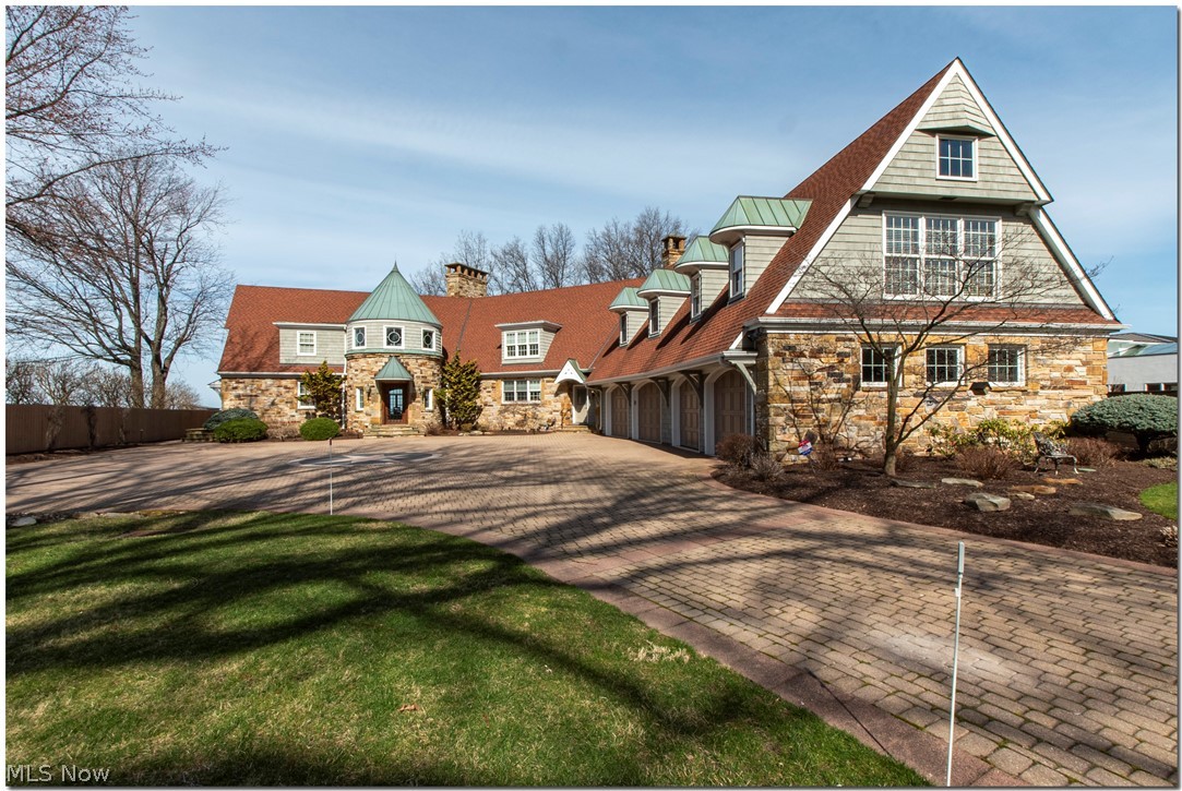 Incredible Lake Erie front custom Hm. with Downtown Cleve. view-Custom designed by Paskevich & Asso.-This 7618 sq.ft. Stone & Cedar Country French Hm. Has 4/6 Bedrms 5 full & 3 half baths-Possible in-law suit if needed-Large kitchen with high end appliances
All generous size rm. thru-out with Lake Erie view. AMENITIES INCLUDE / / All floors including EXTRA Large 4 car garage have ZONED IN-FLOOR RADIANT HEAT/ PLUS Total DRIVEWAY HAS RADIANT ICE MELT / 4 STOP ELEVATOR / Finished Rec rm w/Bar & Fireplace / Private observation rm./ Large great room with custom wainscoting paneling thru-out /Private office with full bath & private entrance/Gazebo / Whole house Generator / Newer boilers / PLUS A/C / Large out building for storage / PLUS ADJACENT LOT 60 X 178 INCLUDED WITH PURCHASE. TOTAL TAXES INCLUDES ADJACENT LOT