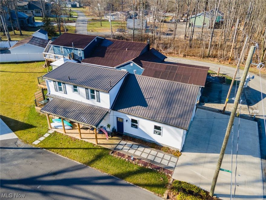 Who doesn't love a LAKE HOUSE?  Just looking at these pictures and you begin to feel that warm, Summer breeze through your hair and the sunshine on your shoulders.  You hear it a lot, BUT, opportunities like this do not come around often.  The GOOD VIBES you remember and the charming character you expect from vacation, waterfront living are in endless supply in this beautifully updated oasis located in the highly desirable Lake Milton community.  THIS TRULY IS A MUST SEE! The updates are stunning and include but are not limited to: a newer metal roof with a great overhang that provides outdoor privacy and picturesque views of the water, double deck for privacy, relaxation, and entertaining from both the first and second floors, a new 2 car attached garage (with an unfinished bonus room above), a newer furnace, newer A/C, newer hot water heater, a newer, large, dry basement complete with high ceilings and glass block windows, all newer windows throughout, beautiful hardwood floors, a romantic newer added fireplace in the living room and so much more.  The character and craftsmanship of this fabulous lakeside getaway are unmatched and just waiting to allow you and your family and friends to make lifelong memories here.  The newer washer and dryer convey as well as the stove and refrigerator.  The home comes complete with a one year home warranty to ensure a worry free purchase.  Just take a moment and scroll back through those photos and let the ambiance of the scenery move you and cause those Summer Vibes to begin to roll.  You can hear the water, feel the heat, see the smiles, smell the outdoors, and taste the tastes of outdoor life @ the lake!  Now, back to reality!!!  This home is ideally located, fabulously updated and competitively priced to sell quickly so do not hesitate.  CALL TODAY for your own private showing and make your dreams a reality!!  (YES, the dock and boat lift highlighted in the aerial views belong to this property!). SELLER IS HIGHLY MOTIVATED!