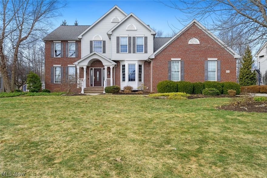 Located on a quiet cul-de-sac in the desirable Bridgeside neighborhood, this beautifully maintained and newly renovated colonial offers 4,550 sq ft of living space (3,350 sq ft above grade plus a 1,200 sq ft finished basement). Set on a wooded, professionally landscaped lot, it provides exceptional privacy and a peaceful setting. The renovated 2016 kitchen—featured in the 2018 NARI Home Tour—includes premium cabinetry, granite countertops, and high-end appliances: Sub-Zero refrigerator/freezer, Thermador range, microwave drawer, and warming drawer. A grand family room with gas fireplace opens to the backyard for seamless entertaining. The renovated primary suite features uplighting, a spa-like bath with decorative shower and heated floors, and spacious his-and-hers walk-in closets. The second floor includes four additional large bedrooms and two full baths. A Wired4 control sound system provides audio throughout the home, deck, and garage. The finished lower level offers a large recreation room with surround sound, premium bar with sink and ice maker, fitness area, and storage. The impressive backyard includes a stone walkway, firepit, two-tier deck, covered porch, built-in gas grill line, and a well-maintained Jacuzzi hot tub with 2026 replacement parts. Additional features include a wide driveway with parking pad and basketball hoop (2017), three-car garage with shelving and attic storage, Azek front door (2014), Ring camera system, newer roof (2011), furnace/AC (2017), Aprilaire humidifier (2017), hot water tank (2024), and double sump pump system with battery backup (2024). A rare opportunity for a spacious, upgraded home ideal for everyday living and entertaining.