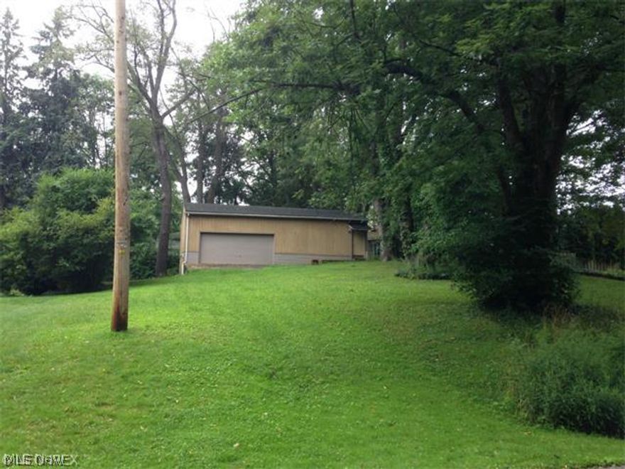 Rare opportunity to obtain a building lot in Twin Lakes! 80'/125' total. Very large (approx. 41' x 21') garage/pole building with additional room for office, etc. and all concrete flooring, sits toward the back of the lot. Garage has electric & has garage door opener (2-car door). Gas & public sewer available at street. City water not currently available in Twin Lakes. Imagine life in this lake community! Access to both East and West Twin Lakes for fishing, boating, swimming, etc. Nice beach area with dive platform, playground, and newer picnic pavilion with restrooms and changing room! Public golf course nearby! Kent City Schools! Quick/easy access to I480 and Ohio Tpk. as well as the revitalized downtown Kent and KSU!