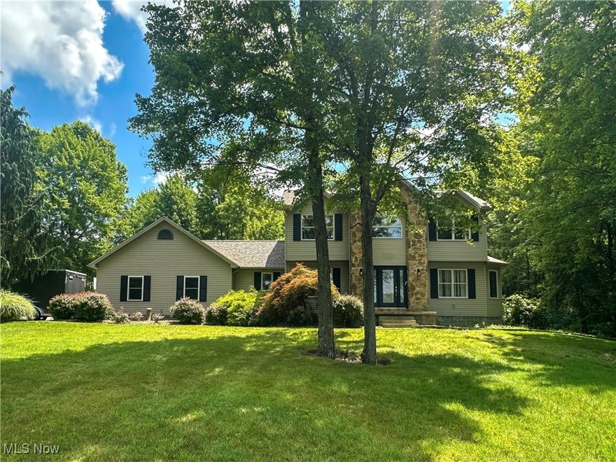 Nestled on an oversized lot with nice setback from the road for privacy, this stately two-story home offers a lifestyle of comfort and recreation. Imagine seeing lovely views of Meander Reservoir from your front yard and catching the MetroParks Bikeway, an 11-mile paved trail for walkers, bikers and skaters, just steps from your door. Inside, discover a meticulously designed 3 bedroom, 2.5 bath haven boasting formal living and dining rooms, a modern kitchen with stunning concrete countertops, a sun-drenched dining area surrounded by windows, and a cozy family room with a fireplace. The open floor plan seamlessly connects these spaces, creating a warm and inviting atmosphere ideal for entertaining. Additional main-level features include a laundry/mud room and a convenient half-bath. Upstairs, retreat to a generously-sized primary suite with his & hers closets and an attached bath with dual sinks and a walk-in shower. Two more bedrooms and a full bath complete this level. The basement offers ample space ready to be customized to fit your needs. The backyard is a private oasis, featuring a sparkling 18x40 inground pool, a sprawling patio and a large grassy area for endless outdoor fun. Important updates include a brand new roof (April 2025), Payne furnace (2022); Payne A/C unit (2023) and new footer drain (2024). Make this dream home yours and experience the best in comfort, style and location! Schedule a private tour today.