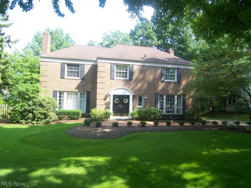 Price Dropped 50k!!  What a find.  This 4 bedroom 3 1/2 bath all brick center hall colonial sits on .6 acres of the some of the most prestigious landscaping in Akron.  With winding walk ways,  multiple patios, and amazing plant life, the rear yard is one of a kind.  There is over 4000 square feet of total living space, with much of the flooring natural hard wood.  A large living room opens to a beautiful morning room, and has one of the 3 fireplaces.  The other is in the open family room with high ceiling that opens to a sun room.  Each of the bedrooms is large, with a master suite and second floor laundry.  The ample closet space is reflected throughout the home.  The finished rec room is 22x14 in the lower level.  Enjoy the wonderful landscape from the over sized deck and multiple patios.  There is a 3 car garage, shed, first floor library, open foyer, large attic space, and so much more.  There is way too much detail to list.  Come see for yourself!!