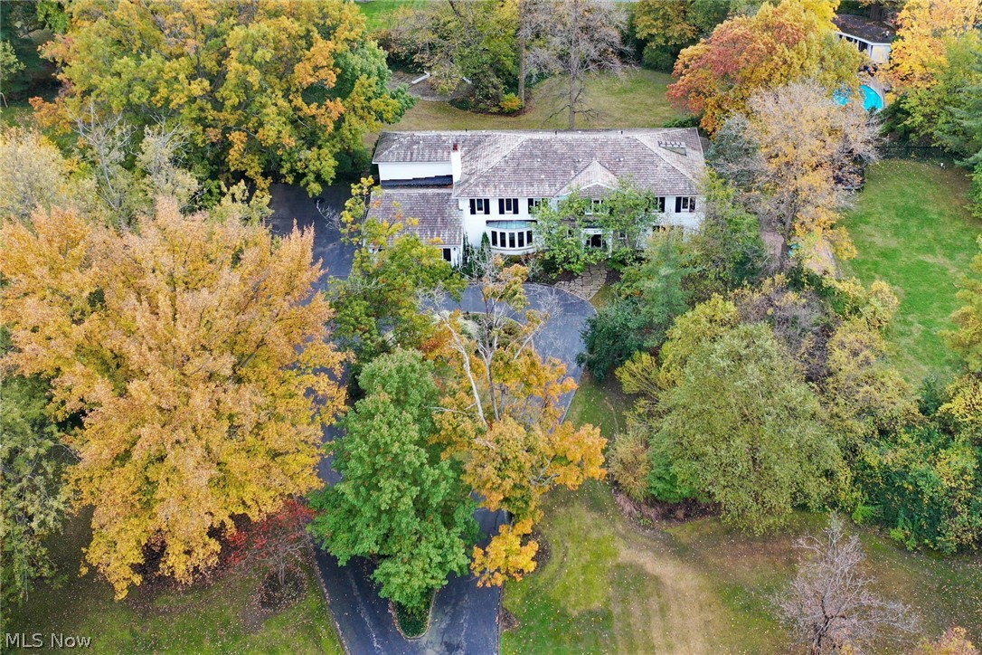Stunning Shaker Hts estate set high on a hill over a bridge located steps from lush hiking trails, parks and nature center. This incredible home has been completely renovated. State-of-the-art chef's kitchen with top-of-the-line appliances &, granite counters, 5 bedrooms, 6 baths, In-ground heated pool and pool house with kitchenette. Elegantly decorated, modern decor, complete with UV air and advanced water filtration systems. Private sprawling 1.4 acre lot with spacious outdoor entertaining area & fireplace, gracious vaulted entry with two-story circular staircase, hardwood floors throughout, huge picture windows with panoramic views of the spectacular grounds, paneled library, luxury master suite with huge closet & dressing room, marble master bath with heated floors, laundry on all 3 levels, central air, finished lower level with bath, 3 attached car garage, security & camera system with keyless entry.