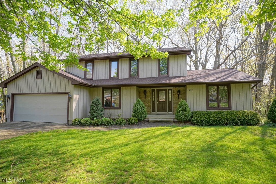 Large 4-bedroom Colonial with spectacular views of Sand Run Park. This original-owner home has large formal living room with crown molding which has sliding doors to brand-new, 2nd story deck and French doors to fireplaced (brick) family room. Large, applianced kitchen includes extra breakfast room with wall of built-ins and bay window facing the park. There's also a formal dining room with crown molding and chair rail. Also included on the first floor is a half bath, laundry room with utility tub and entry to attached 2-car garage w/electric and hot/cold water. Upstairs is master bedroom with it's own deck, walk-in closet with vanity and master bathroom. There's three more bedrooms, two with double closets and one with shelving, and the main bathroom which has "separate" 2nd vanity/sink. Lower level includes "L" shaped rec room or could be two separate rooms, workshop area, utility/storage room with built-in shelves, additional storage "room" and half bath. Basement walk-out le