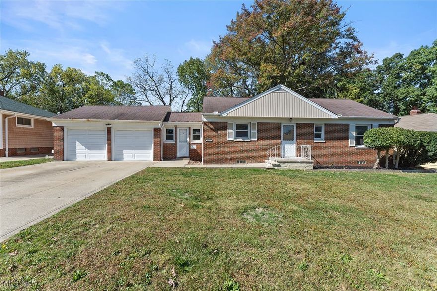 Welcome home to this beautifully refreshed all-brick ranch with a walkout lower level and over 1,600 sq ft of finished living space! Step inside to find a warm, light-filled living room featuring oversized windows with views of the private backyard and new flooring that flows seamlessly throughout. The kitchen offers freshly painted cabinetry, solid surface countertops, tile backsplash, and all new stainless steel appliances ready for your first home cooked meal! Both bedrooms are spacious with new carpet, fresh paint, and modern lighting. The lower level is a true extension of the home, featuring a cozy recreation room with a stone fireplace, an additional finished room perfect for guests or a home office, a full bath, and a walkout to the backyard surrounded by mature trees. A covered breezeway connects the home to the oversized two car garage, adding convenience and charm. With all new flooring, lighting, paint, and appliances throughout, this move-in-ready home perfectly blends character and modern comfort. Ideally located close to freeway access and just minutes from downtown Cleveland, the perfect combination of comfort and convenience!