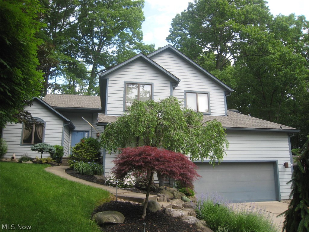 This custom built multi level contemporary is designed for today's busy life style and casual living. Situated in a serene cul de sac, you can hear the waterfall softly flowing as you approach the front door. Standing in the foyer, you can see the open, flowing floor plan and beautiful hardwood flooring throughout the living space. The cathedral ceilings and tall windows allow for soft filtered light to enhance each room. The living and dining rooms are just steps away from the gourmet kitchen. Stainless steel appliances, corian counters, double pantry and a built in desk are just a few of the features. The island is perfect for informal eating, food prep and entertaining. The bow window in the eating area overlooks the deck with a stone fireplace. The family room with woodburning fireplace walks out to an expanded patio. There's room for your big screen TV, accessories and a pool table, too. An office, bedroom, freshly painted and carpeted, and bath are on this floor. The rec roo