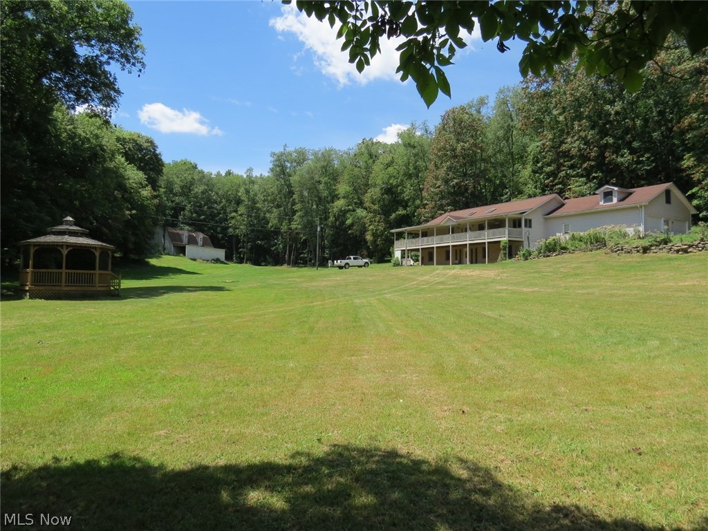 Nice Country 20.9 Acres with Handy Location! Quality 1996 custom built ranch home on a fully finished walkout basement and approx. 3456 sq ft of living space. The home features a wrap-around porch, 3 bedrooms, 3 1/2 baths, geothermal heating and cooling, and huge 33x14 room above 2 car attached garage for hobbies, etc. There's also a good 28x50 gambrel roof barn with attached shed and partially finished upstairs that has plenty of work space or storage. A large portion of the tract is wooded which affords lots of wildlife and timber as well. This property has high visibility on St Rt 43 but the home is situated back the winding lane and has plenty of privacy! This property is well suited for personal or business use with no zoning. All minerals owned will transfer with property. Taxes shown reflect full amount without the Homestead Reduction. New tax amount TBD after new survey. Additional acreage is available. Students may attend school in brand new bldgs. Call to view this wonderful