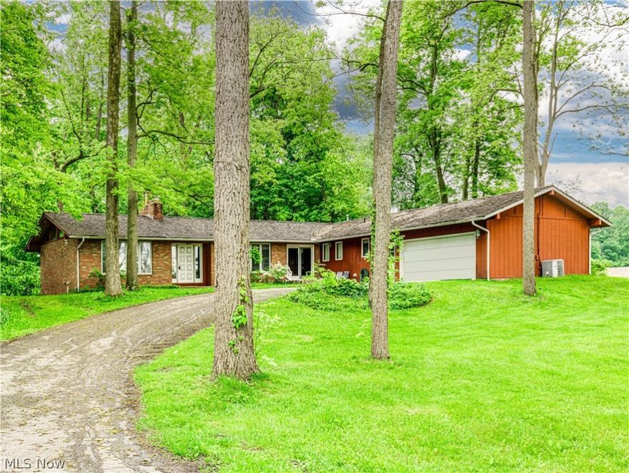 Welcome to this incredible ranch-style home complete w/5 Beds, 4 full baths & situated on a picturesque 2.30-acre lot. Surrounded by mature trees & overlooking a tranquil ravine out back, this property combines comfort and the beauty of nature. With spacious living areas, multiple fireplaces, and thoughtful design details, this home is perfect for those who love to entertain.  2161 sq. ft. on the main level includes the open-concept kitchen, living, & dining area. The massive living RM features LRG windows all around w/vaulted ceilings. You’ll enjoy the double-sided wood-burning stone fireplace w/glass panels that separate the living rm from the Great rm/office. The primary suite is a private retreat, boasting 3 closets & a full bath. Just off this room is a spacious relaxing area w/jacuzzi tub & full bath. You will fall in love with the sunroom. This area is ideal for enjoying morning coffee while enjoying scenic views. From this area, a sliding glass door provides access to the deck which overlooks mature trees showcasing nothing but privacy. The 837 sq. ft. walk-out LL offers a family room with a brick fireplace; perfect for a cozy movie night. There is also a small kitchen and 2 addt'l beds & a full BTH. This level also includes a second laundry room, adding additional convenience. The walk-out feature provides easy access to the beautiful backyard and treed lot. There is an additional basement with access from the master bedroom. The home's exterior is equally impressive with a brick pathway leading to the front door, a long winding driveway, and beautifully landscaped surroundings. This would be a great home for a possible LL rental. Come see how incredible this home truly is.