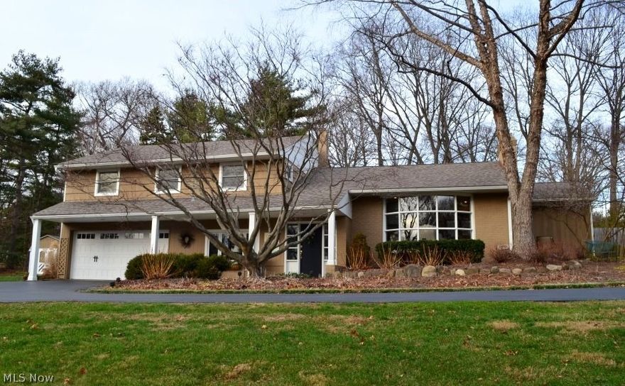 Welcoming split level home, perched on slight hilltop, features very open floor plan with numerous updates.  Inviting, covered front porch, with pillars, leads to bright and airy entry.  Engaging great room boasts mantled brick fireplace, built-in shelving, and large bay window.  Spacious dining room presents glass French doors to patio.  Completely re-done kitchen offers extensive Kraftmaid cabinetry, peninsula breakfast bar, recessed lighting, patio access, and overlooks eating area.  Large master suite with ceiling fan and private bath.  Three additional bedrooms and main, full bath complete the second level.  Sunken den/family room with half bath located nearby.  Generous sized mud room with access to garage and backyard.  Fabulous lower level recreation room, with floor to ceiling brick fireplace, and ample storage space.  Recessed lighting througout.  2.5 car, attached garage.  Multiple patios.  Large yard with privacy fence and perennial gardens.  Shed.  Newer windows and roof (