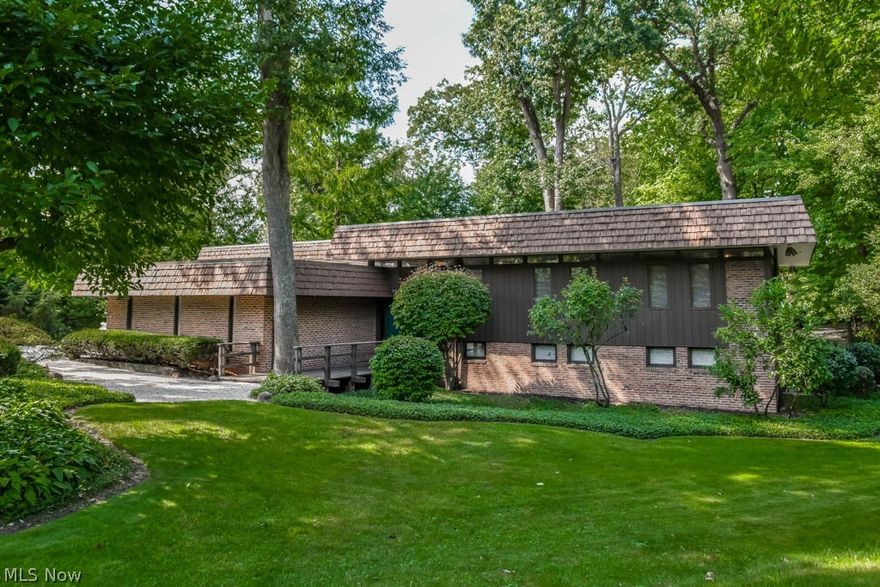 One-of-a-kind Frank Lloyd Wright inspired home! At the end of a cul de sac on a remarkable, serene lot - fenced with a tiered deck, inground pool and graveled trails. Inside has been beautifully restored to a like-new original state straight out of a different era! Incredible double-door entrance to a wide foyer with steps up to the living room. Sliding doors to the deck are present in the living room, dining room, dinette and great room. Crack open your cookbook in the kitchen with original cabinetry, LED under cabinet lighting, a pantry and dinette. The hallway to the bedrooms is lined with built-in storage and transom windows. The master suite has a walk-in closet, deck access and a private full bath with a tub and separate shower. There are 3 additional bedrooms and a full bath with double sinks. On the way to the lower level, an amazing great room resides on a half level. It boasts 11.5-foot ceilings, a woodburning fireplace and built-in shelving. This level includes a laundry room and a half bath off of the heated 2-car attached garage! The lower level offers a rec room with sliding doors, a second rec room with an 18x11 attached storage room and a bonus room with a full bath and walkout access - perfect for cleaning up after swimming! Plus a workshop in the basement! Two 93% efficiency Lennox furnaces (2011). Your backyard paradise has a 20x40 inground pool that is 10-feet deep with a newer heater, a shed and a tiered deck with a 56x8 top tier! Truly a must-see home!