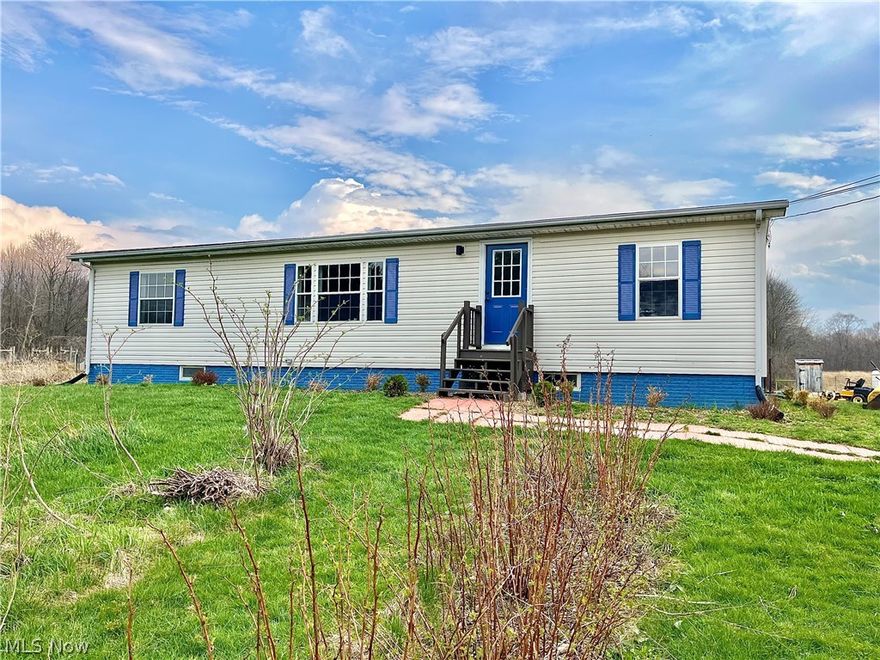 Farm Living is the Life for me! If you've ever wanted to live the farm life, this 3 bedroom 2 bath manufactured home set on a full basement might be just what you've been looking for! The 15+ acre parcel features a barn w/workshop or implement storage area, gated pasture land, chicken coop and pen, pond, plenty of wooded area, a greenhouse and a wide variety of fruit trees (apple,plum, pear, asian pear and nectarine), berry bushes (raspberries, blueberries, elderberries, strawberries) and garden vegetables. The 1450+ sq ft home has been COMPLETELY updated in 2025/26 and boasts an oak kitchen with butcher block tops, deep well farm sink, stainless steel appliances, slider to the rear yard patio, LifeProof Flooring throughout, 1st floor laundry, utility room, mud room and 2 better-than-new full baths. Paved road, well, septic and AC. Basement offers additional finished living space opportunities. Come out to the Country and escape!