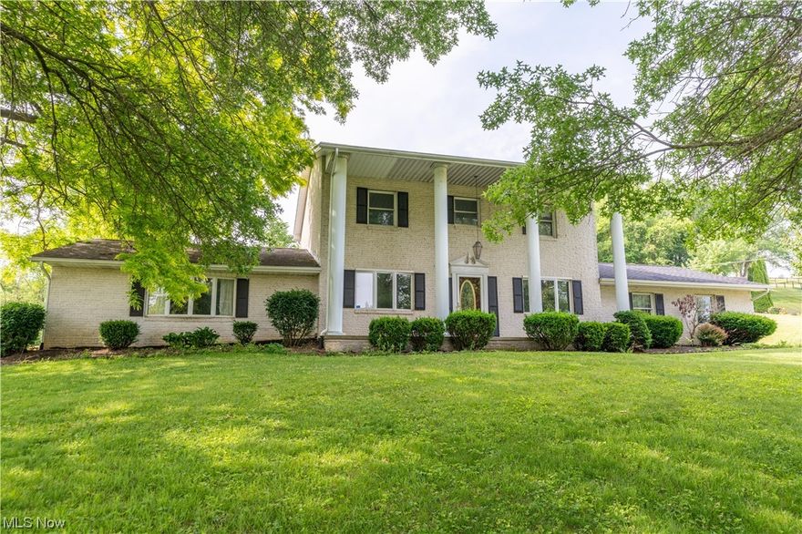 Brand new carpet throughout and some rooms freshly painted. This 2 story all brick Colonial rests on a gorgeous wooded 1.22 acre hillside double lot.  The large covered front porch offers plenty of space to relax and enjoy the country setting.  The first floor has a cozy family room with a stone wood burning fireplace, bay window and a 1/2 bath.  The large oversized dining room is great for entertaining.  There is a smaller area which makes a great office or craft room. A Great Room addition was added  with a wood burning fireplace which has been cleaned every year.  The second level offers three bedrooms.  The master bedroom is extra large (22 X 12) The full bath has a jetted tub and tiled floor.  The unfinished LL has been roughed for a wood burner, has been professionally waterproofed with a transferable warranty, has an industrial sized grinding sewer pump and dehumidifier.  You and your dogs if you have them  (invisible fence with 2 collars included ) can enjoy the large, beautiful tree lined backyard from the concrete patio or gazebo.    Tuscarawas Valley Schools. Minutes from I 77 and midway between Canton and Dover.