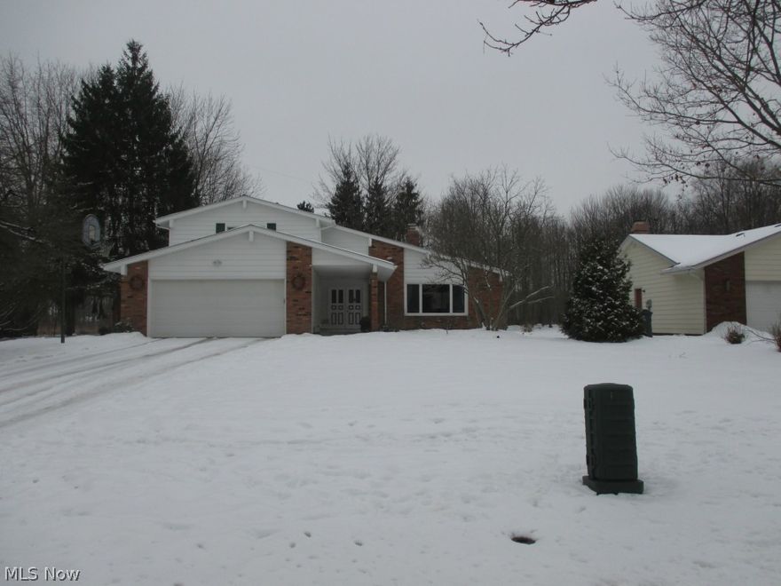 Move right in to this beautiful and extremely well kept 4 BR split in the award winning Solon school district! The open floor plan on the main level includes a carpeted living room with high ceiling, a very spacious dining room with wood like flooring and decorator colors, a bright kitchen that includes all appliances and family room with fireplace wall and sliding doors to the gorgeous back yard.  The peaceful winter serenity of the yard will soon give way to a trex deck, brick patio and walkway, perennial gardens, and privacy landscaping.  Please note the seasonal pictures of the yard that are included.  The main floor also includes an office ( or bedroom # 4 ) a refreshed half bath, and a first floor utility room - the washer and dryer will stay. The second floor master includes a walk in closet and full bath.  Bedroom # 3 has built in book shelves that open into a lighted storage area! The lower level includes a recroom and large workshop area. This home has a newer furnace and C/A