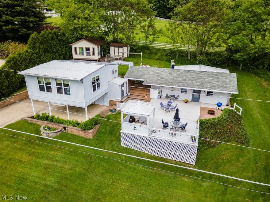 Lake View Home… with a DOCK!  Want to buy a home with instant EQUITY, this is it!  
*Appraised at $232,000 (FHA with no repairs) and buyer backed out. Nothing is wrong. 
*Buy this 10% down second home, AND rent it short term! It’s a WIN/WIN!  

The main home features 2 bedrooms and a full bathroom, or could be converted to a one bedroom with more living space.  The area above the carport is a large open living space, kitchen, and half bathroom, but would also function as a game room, bonus room, gym, etc.  This property could be used in so many different ways. The property includes parking,(a premium at the lake)  and is also close to public parking and the public beach. The camper in the back with an attached porch could make for a sleeping bunk, play space or art studio. Think outside the box! There is also a massive amount of deck space to take advantage of the views, and the pergola has been wired for a hot tub. Don't delay...summer is coming!