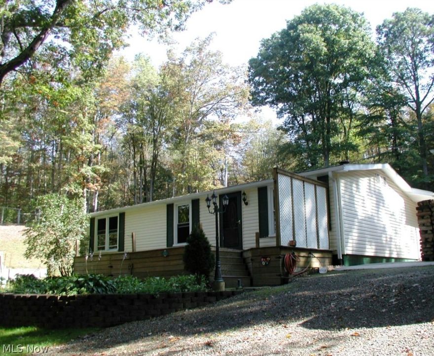 Manufactured home that is tucked away on 2.12 acres that is completely fenced overlooking your spring fed stocked pond. Cozy living room with awesome hardwood floors is highlighted by a woodburner to keep you nice and toasty on those cool nights. Spacious family room with a warming fireplace is perfect for relaxation or home entertaining. Convenient kitchen offers beautiful hardwood floors. Total of 3 bedrooms tops off this very nice home. 2 car detached garage and 18x20 shed is all you need for your supplies. Surrounded by woods and lovely landscaping can be all yours. It's also conveniently located in the Atwood Lake region. What a welcome escape from the city bustle! Seller does not own oil and gas rights.