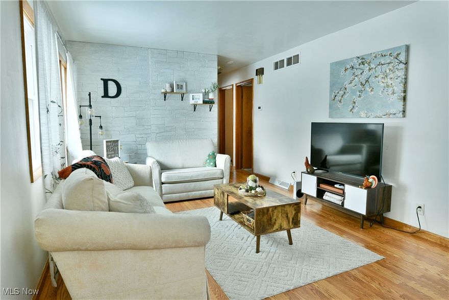 Just as cozy as a warm blanket on a snowy winter night, this charming Liberty ranch will wrap you in comfort away from the cold! Proudly showcasing its desirable three-bedroom layout, this delightful residence has everything you’ve been looking for. Located in a desirable neighborhood, close to local schools, this home offers plenty of curb appeal with its handsome, earth tone exterior marked by accenting green shudders. A detached two car garage offsets the fenced in backyard and covered rear patio area. Through the front door, an inviting living room opens with plenty of natural light and gleaming, hardwood styled flooring. Steps further, a galley kitchen delights with gorgeous looks courtesy of the wooden cabinetry, stainless appliances and stone-look countertops. A rear set dining room offers easy access to the rear patio along with the basement entry. Down the main hallway, a brightly lit full bath enthralls with its elegantly tiled walls and shower surround, tied together with a quaint vanity and adjacent towel closet. Three spacious bedrooms branch away nearby, completing the floor with a surprising amount of living space. Down below, the full basement brings both rec space and a second full bath. Laundry service hides around the far corner.