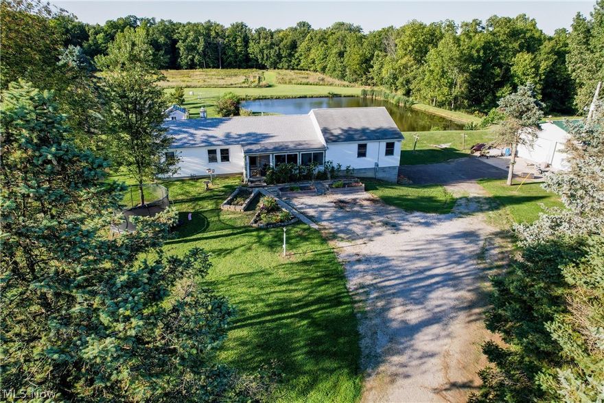 Have you been looking for simple living and a beautiful piece of property to enjoy? Look no further! This property offers just over 13 acres with a mature apple orchard, cherry, pears, peaches, blackberries, blueberries and more! A 1/2 acre stocked pond is an added bonus along with a campsite and large fire pit in the woods, a shooting range, a beautiful creek running through the woods, a 50x50 workshop with natural gas (water and sewer lines ran) with wood-burner and a beautiful built in bar! Also offers a trapping shed to work on all your hunting projects in and a 1/4 acre fenced in pasture with two stalls in smaller barn for your livestock. Home is a 3 bedroom, 2 bath home with a newer master suite that walks out to a large enclosed patio that overlooks the pond. Two car garage underneath the home and lots of extra storage in the basement. Call your favorite realtor today to view this beautiful property!