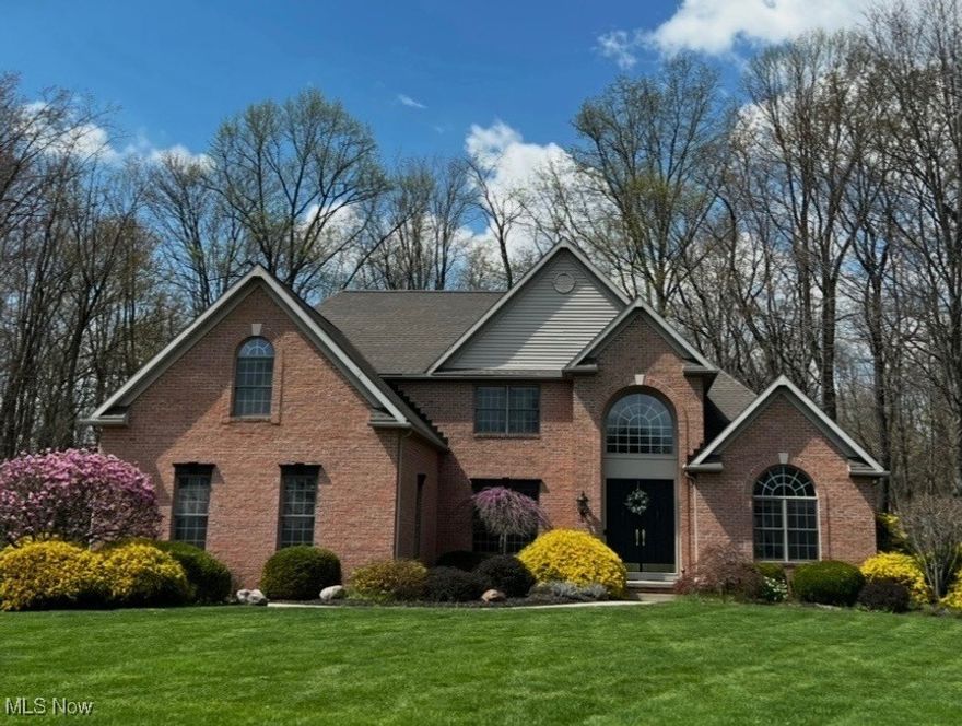 Stunning custom-built colonial in Windy Hill Estates of Wadsworth. This Galehouse built home sits on 1.73 acres with a wooded view and features the following amenities: GEOTHERMAL heating and cooling system, gorgeous hardwood floors throughout most of the main level, dramatic vaulted ceiling in the foyer and great room, first floor master suite and office, beautiful views of the wooded backyard with ravine and creek, 3-car attached garage and beautifully landscaped yard. You will also enjoy the custom kitchen with a huge center island that features French doors opening to a custom brick patio and firepit for relaxing and entertaining. This is a very sharp home with many amenities including Wadsworth utilities.