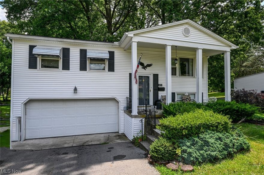 Looking for a new home before the summer is gone?  Here is your chance!!  This large home with stately pillars, sits on a fantastic .32 acre lot.  Inside you will love the beautiful hardwood floors that run through the main level!  Spacious living room is full of natural light and flows right into the dining room.  The fully applianced kitchen features ceramic tile floors, plentiful cabinets and a great cut out for visibility of the dining and living room.  Down the hall is a large coat closet, linen closet, 3 bedrooms and a full bathroom.  All the bedrooms have the gorgeous hardwood floors and ceiling fans.  Don't forget the huge lower level!  The over-sized rec/family room is a great hang out spot.  It even comes equip with a large bar with taps!  This space could even be split up to add a 4th bedroom!  There is also a big half bath here too.  The huge enclosed porch is one more bonus space that you will be sure to enjoy!  Whether you have kids, pets or just like a lush green space,