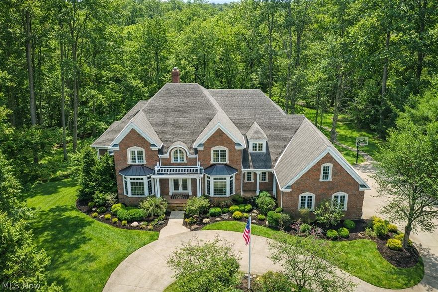 Welcome to this beautifully renovated 4-bedroom, 5 full and 1 half bath home located in highly desirable Glencairn Forest within the award-winning Revere School District. This exceptional property offers the rare convenience of both a first-floor primary suite and a second-floor primary suite, providing flexible living options for a variety of lifestyles. Step inside to a stunning two-story foyer, flanked by a formal living room with fireplace and an elegant formal dining room. The brand-new chef’s kitchen is the heart of the home, featuring a large center island with seating, commercial-grade Thermador appliances, beverage center, and a spacious walk-in pantry. The kitchen flows seamlessly into the breakfast room with fireplace and impressive two-story Great room with fireplace, where a wall of windows and French doors lead to an outdoor terrace, showcasing picturesque views of the private, resort-style backyard and pool. The first-floor primary suite is generously sized and offers a private retreat with a fireplace, full bath and walk-in closet. A private office/den, renovated mudroom/laundry room, and half bath complete the main level. Upstairs, you’ll find three additional bedrooms, each with its own en-suite full bath, including a second primary suite, perfect for guests or multi-generational living. The fully finished walkout lower level is truly one-of-a-kind, featuring a full bath, theater room, craft room, and expansive recreation space, along with custom built-ins including a play slide,  ball pit area, and a charming playhouse, creating a fun and functional space for all ages. Outside, enjoy a private backyard oasis complete with a resort-style pool and a cozy cabin retreat with a wood-burning fireplace, ideal for year-round entertaining. Additional highlights include public water and sewer (no well or septic). This extraordinary home offers luxury, functionality, and unforgettable spaces. Schedule your private showing today!