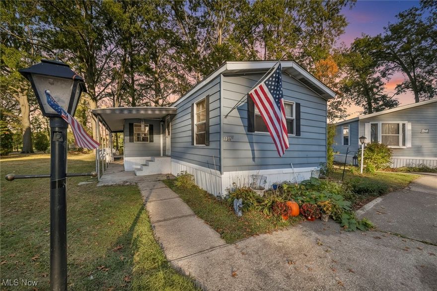 Welcome home to this well-maintained and move-in ready Three Bedroom, Two bathroom ranch-style manufactured home located in the desirable Ridgeville community of North Ridgeville!  Offering 980 sq ft of comfortable single-level living, this property is perfect for anyone seeking an affordable, low-maintenance, and convenient lifestyle in a peaceful suburban setting.  Step inside to discover a bright and inviting interior featuring an open floor plan, updated flooring, neutral paint, and large windows that bring in plenty of natural light.  The spacious living room provides a welcoming space to relax or entertain, flowing easily into the dining area and kitchen, which offers ample cabinet space, laminate counters, included Range appliance, and room for a cozy dining setup.  The primary bedroom includes an en-suite full bath, while two additional bedrooms and another full bath provide flexibility for guests, a home office, or hobby space.  Enjoy the convenience of in-unit laundry with hookups for both washer and electric dryer. Updates include a newer forced air furnace with the potential to add central air if desired, newer lighting, fresh flooring, and energy-efficient storm windows. Outside, you’ll find a partially fenced yard with room to garden or gather, a patio for outdoor dining, a storage shed, and a covered carport with space for two+ vehicles.  The home sits in a quiet cul-de-sac surrounded by sidewalks, curbs, and streetlights, offering a safe and friendly environment for evening walks. Located on leased land with a low monthly lot rent that includes community maintenance, this property is a great budget-friendly alternative to traditional homeownership. Just minutes from shopping, dining, parks, schools, and highway access, you’ll enjoy the perfect blend of convenience and comfort.  Whether you’re downsizing, buying your first home, or seeking a peaceful place to settle, this charming property is ready to welcome you—schedule your private showing today!!!