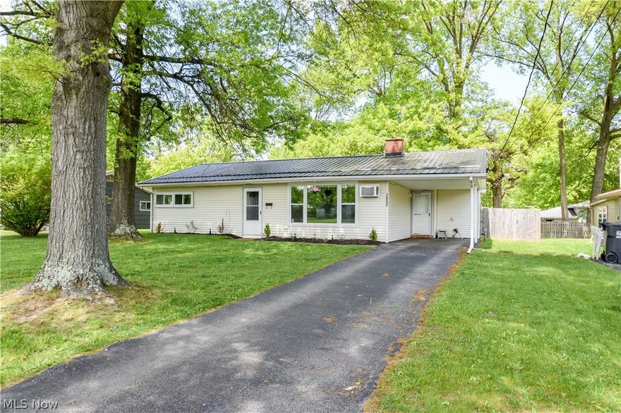 Move in ready 3 bedroom ranch featuring lots of updates. Step in the front door and view all new flooring that enhances the home's inviting atmosphere. Spacious living room with vaulted ceilings, lovely fireplace and a large picture window to let in the natural light. Updated kitchen with newer backsplash and all appliances stay. Full bathroom featuring new vanity, flooring, lighting and updated tub. French doors off the kitchen lead to a beautiful patio, fenced in yard ideal for outdoor relaxation and entertainment and also a bonus for dog lovers to let their pets run. Newly installed metal roof (fall 2022) that reflects heat to insure durability and peace of mind, nicely landscaped yard, shed for storage and covered attached carport.  Functional, stylish and ready to be your new home. Call today.
