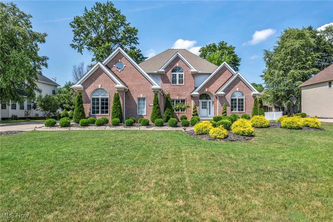 Welcome home to this stunning Modern Colonial situated in the sought-after Kerrington Estates in Westlake. From its classic brick façade, architectural gabled rooflines, and elegant Palladian windows, to its spacious open floor plan, this home is designed to impress. Step into the vaulted Great Room, where a wall of windows floods the space with natural light. Enjoy cozy evenings by the fireplace, enhanced with built-in surround sound—perfect for entertaining or relaxing with family. The Great Room flows seamlessly into a gourmet kitchen featuring granite countertops, sleek European-style cabinetry, and a generous center island—all thoughtfully updated for today’s lifestyle. The first-floor master suite provides a private retreat, featuring a walk-in closet, dual vanities, a Jacuzzi tub, and a separate shower. Rich wainscoting, built-in shelving, and hardwood floors define the sophisticated study/library. Upstairs, you’ll find three spacious bedrooms—two sharing a Jack and Jill bath and one with a private en-suite—plus a versatile bonus room above the three-car garage, ideal for a playroom, studio, or additional office. The finished basement adds even more living space, with a large recreation room, a dedicated media room with surround sound, and a full bath—perfect for game nights or movie marathons. Additional highlights include a side-load three-car garage, a private patio for outdoor entertaining, and professional landscaping that adds curb appeal. Located minutes from I-90 and I-480, Westlake Library, the Rec Center, and the shops and restaurants of Crocker Park, this beautiful home offers the perfect blend of luxury, comfort, and convenience.