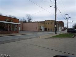 Large commercial building with access for larger trucks, plenty of warehouse space, large parking area. Includes a retail area separate from the warehouse area. In addition, two apartments above the office area. Many potential uses. All offers must be approved by the court.