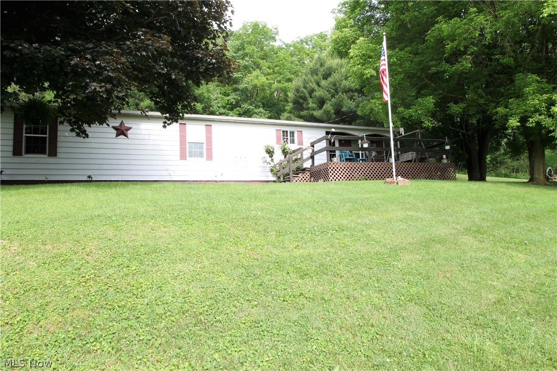 Picturesque privacy on this 3.26 acres offering the feeling of being secluded but just minutes from Tappan Lake. This home offers a deck in the front where you can sit out and enjoy the stunning views. There are three bedrooms, two full baths, living room with wood burner which can heat the home, dining room, large kitchen. The kitchen has a cooktop, bar sitting, wall oven, refrigerator and all open to the dining room. The backyard you will find a patio leading from the home so you can sit out and enjoy the fabulous views, or entertain, two car carport, two sheds that have electric. New hot water tank (2020). Nothing better than a postcard setting!