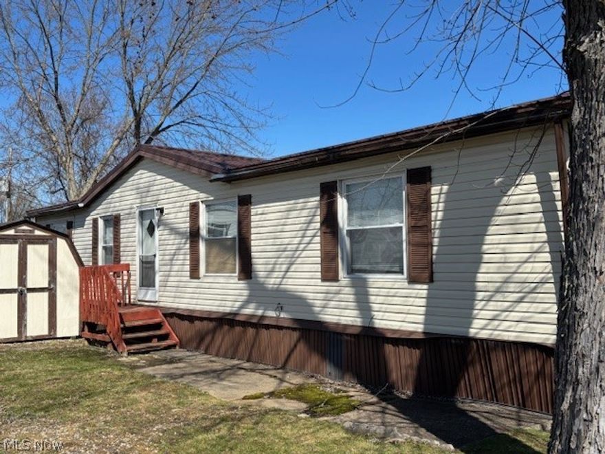 Welcome to this spacious 3 bedroom, 2 full bath manufactured home located in Jacques Mobile Home Park, conveniently situated at the corner of Route 322 and Aquila Road in Chardon. Enjoy the outdoors from the beautiful new deck (2025), perfect for morning coffee, relaxing afternoons, or weekend cookouts. This home also features a metal roof that is approximately three years old, offering added durability and peace of mind.
Inside, you are welcomed by a convenient laundry area that flows into the spacious kitchen with ample cabinet storage. The kitchen opens to a large living room and dining area, creating a comfortable layout for everyday living and entertaining. The primary bedroom includes its own private full bathroom, while the second full bath is located between the two additional bedrooms. One of the secondary bedrooms also features a cedar closet for added storage.
Per park management: Buyer is responsible for water, sewer, electric, yard, driveway, and walkway maintenance. All buyers must be approved through the Jacques Mobile Home Park application process prior to submitting an offer and must be 18 years or older to apply.  https://gemstonecommunities.com/properties/jacques-mobile-home-park/
Schedule your private showing today! (note:the living room window is in the process of being repaired)