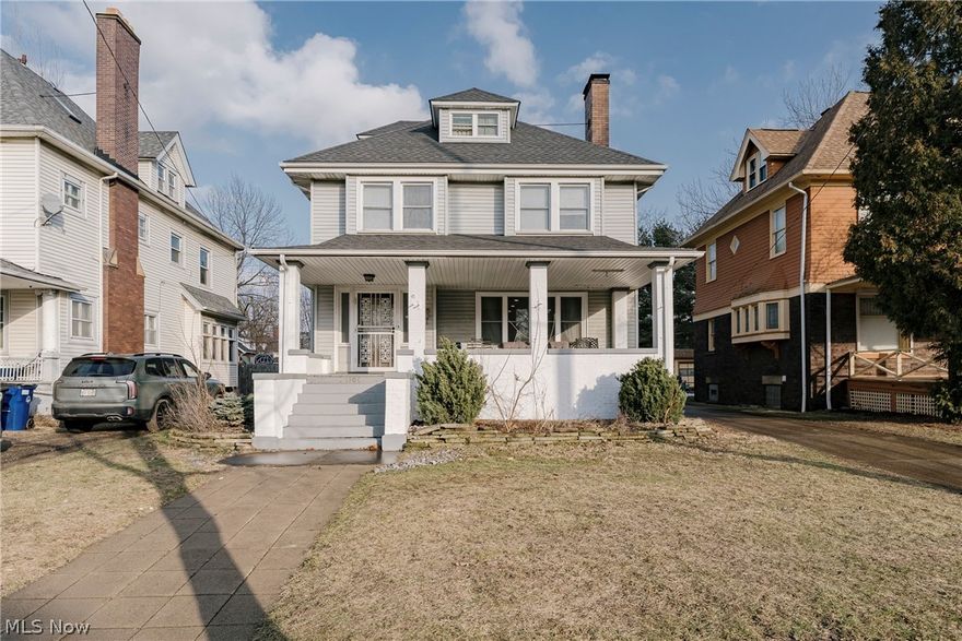 Welcome to 1507 E 108th St – A Classic Colonial just blocks from University Circle! This beautiful colonial blends timeless charm with expansive living space, offering the perfect setting for a large or growing family. Step onto the welcoming front porch and into a gracious foyer highlighted by stunning leaded glass sidelights. The foyer opens to an expansive living room filled with natural light, showcasing beautifully refinished hardwood floors and a striking sandstone fireplace that creates a warm and inviting focal point. The living room flows seamlessly into the spacious formal dining room—ideal for hosting gatherings, holidays, and everyday family moments. The updated kitchen combines character and functionality with updated cabinetry, rich wood countertops, charming shiplap accents, and hardwood flooring. A convenient half bath completes the first floor. Upstairs, the second floor features four generously sized bedrooms with hardwood flooring and an updated full bath. The finished third floor expands the living space even further with three additional bedrooms and a second full bathroom—perfect for guest suites or home offices. The full basement is currently unfinished and includes a laundry area with washer and dryer (2025), offering abundant storage and future finishing potential. Recent major updates provide added peace of mind, including a new furnace (2024), refinished first-floor hardwoods, and a roof replaced in 2018. This home is move-in ready and full of character, offering incredible space, flexibility, and comfort. Don’t miss the opportunity to make it yours!