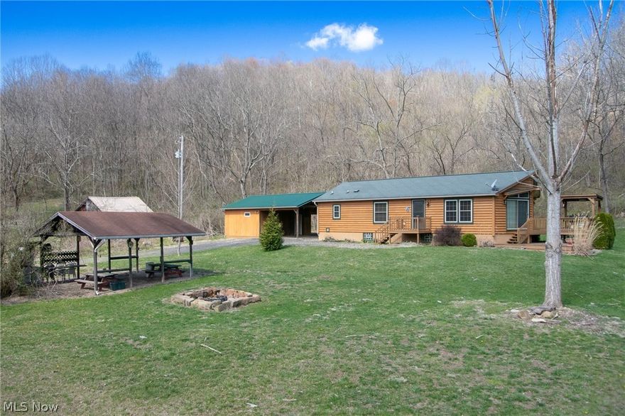 39190 Road Fork Rd. Lower Salem, Ohio 45745 is paradise on earth! Beautiful property, 69.93 acres, this Private Retreat is nestled next to the Wayne National Forest & almost 60 acres of this land is wooded & 5 miles of ATV trails for riding & exploring; 2 ponds, 2 OR 3 bedroom, 3rd is a large addition previously used as Family Room, 2 bathroom log sided RANCH home & spacious full basement, huge outbuilding w/ carport, plenty of room for vehicles, tractor & toys! Great secluded home for year round living or hunting lodge or vacation home! Just 2 hours South of Akron in Noble County. Swimming & fishing pond can be viewed from the 2 tiered deck w/ covered grilling & smoker deck & from the Great Room 2 sets of 8' sliders & Open Kitchen w/ cathedral ceiling! Kitchen has plenty of counter space including an island w/ seating & unobstructed views of the absolutely stunning setting! Appliances included! Come relax in your own secluded paradise to hike, hunt, swim, fish, grill or smoke your own