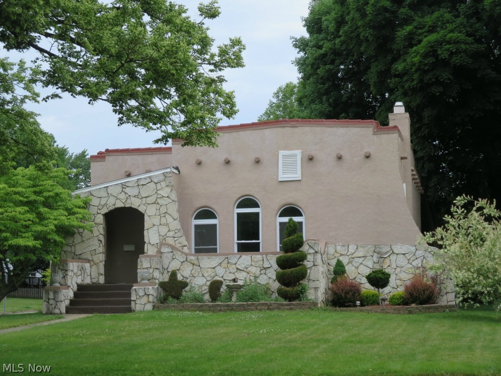 If you have a flair, you’ll want to grab the chance to live in this wonderful 3-bedroom, California-style stucco ranch on beautiful Chestnut Blvd., in Cuyahoga Falls. With custom work already done, the house will be super easy to live in. Neutral colors throughout, clean lines, fresh paint, thermopane windows for energy efficiency, and an updated kitchen that is a cook’s dream. It has lots of counter space, loads of cabinets and 10 drawers for storage, even! All appliances stay, and are newer. The living room is light, bright and has a wall of windows with architectural round tops on one wall, and two others with a fireplace in between, on the other. The furnace, central air, electric, plumbing and water heater were all replaced in 2007. The basement is plumbed for, and has framing for a second bath, and the large, corner lot has a wrap-around yard with ornamental landscaping that is just beautiful. You’re within walking distance to parks and the Quirk Cultural Center, and there's even