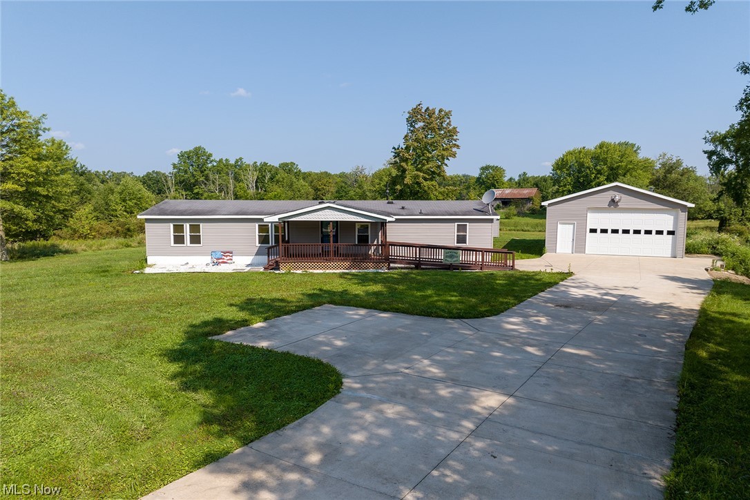 Come check out this beautiful manufactured home on a large lot at almost 1.5 acres. Double concrete driveway with turnaround leads right up to a massive garage with an oversized door a shop bathroom. The freshly stained covered deck leads up to the home where you are invited in to a very large great room
with vaulted ceilings for all of your entertaining needs. The kitchen is open to the great room and features a nice breakfast bar and large pantry. The master bedroom is complete with a large bathroom with soaking tub, and separate shower. Two bedrooms on the other side of the home with a Full bathroom complete the tour. Don't miss out on this incredible opportunity to own a piece of country heaven. Schedule your showing today!!
