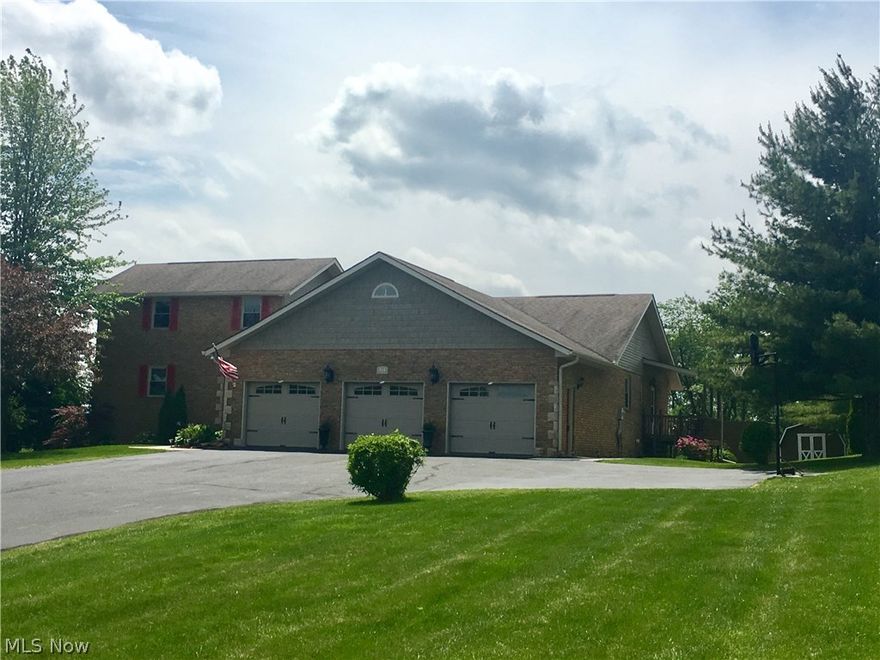 Take notice of this once in a lifetime opportunity! After you park in the oversized 3 stall garage, you'll enter the mud room which divides the two living areas. Through the door on the right, you'll enter a large, well equipped 1 bedroom "mother-in-law suite". The door to the left, enters to a huge open kitchen and formal dining room. Tons of cabinets with lots of counter space, a large island and all the space you need for those holiday meals. There is also a sunroom connecting the home to the additional suite. The living room features a cathedral ceiling and a wall of sliding glass doors overlooking the view of the valley. One bedroom and a full bathroom can also be found on this 1st level. The entire second level is dedicated to a beautiful master suite, with a large walk-in-closet and an on-suite bath. Taking the extra wide stairway to the walk-out lower level, on your left, you will find a huge-open dining room and equipped kitchen with plenty of counterspace and storage. To your