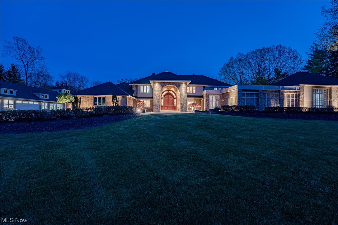 Nestled on 5.7 acres of private wooded land in Moreland Hills, 32700 Jackson is easily one of the most iconic properties in Northeast Ohio. Renowned for its unparalleled amenities and forward-thinking design, this truly magnificent estate has been meticulously updated and improved by the current owner. From the 16-seat home theater, to the 14+ capacity garage complex, to the spa and treatment rooms, this property has absolutely everything and is truly a once in a generation offering. The double height foyer opens to the grand staircase silhouetted against massive walls of glass. Sculptural design elements play against the tremendous light pouring into the great room beyond. The remodeled chef’s kitchen is appointed with Wolf and Subzero appliances, contrasting stone counters, and an informal open dining area. For larger gatherings, a sprawling ballroom with six sets of French doors is easily accessed. The extensive primary suite is sequestered in its own wing and includes a massive, grand bedroom, dual dressing rooms and dual luxuriously appointed baths. Outside, a magnificent 8000 sq ft sandstone patio offers multiple points egress for seamless transition to the pool, waterfall and whirlpool spa. An outdoor pavilion, a refinished tennis and basketball court, and a large, stocked pond complete the grounds of this sprawling estate. All of this is set against a rolling landscape positioned between the 4th and 5th holes of the championship course at Chagrin Valley Country Club.