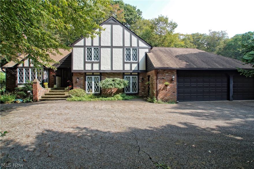 Located in the heart of Munson, this 3100SF 4 bedroom, 3.5 bath masterpiece sits way back from the road in as secluded of a setting as you can get. This Tudor style split level has been beautifully maintained on the outside and is even complete with a in-ground pool plus a HUGE 34x40 pole barn with loft storage. Inside the home you are greeted with beautiful Tudor charm and solid hardwood everywhere. The kitchen has been remodeled and includes custom cabinetry, granite counters and newer flooring. The original 3 car garage was converted to a massive family room with separate entrance and a new 3 car garage added on. Also located on the first floor is a huge laundry room, den, office, sitting room, and formal dining room. Overlooking nature and the in-ground pool is one of the most beautiful enclosed patio's that you will ever see.  The basement is partially finished but still offers a massive amount of storage room. The 2nd floor features a full owners suite addition that allows for the other 3 large bedrooms to stay as kids or guest rooms. 2 full baths and a half bath are on the 2nd floor as well. This home is truly an inspired lifetime labor of love and it shows in every single room. Come view this truly remarkable home today.