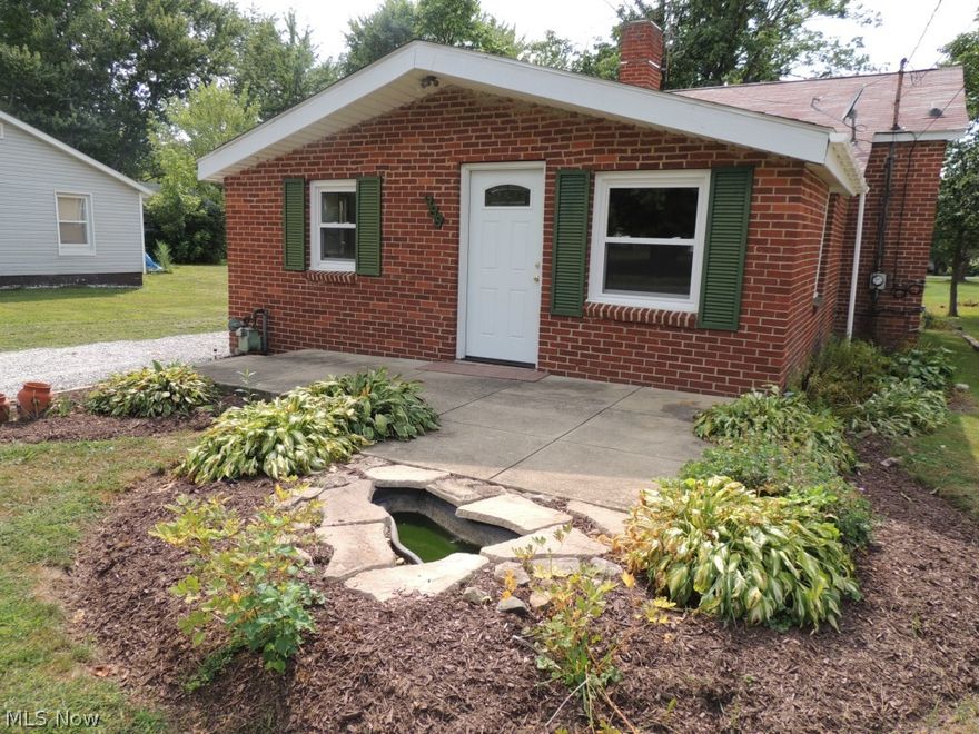 Lovely 2 bed/2 bath split-level with a full basement that is move-in ready on a quiet street in the Springfield-Mogadore area! Roof replaced in 2009. All new windows in 2014. New gutters and downspouts in the basement to be installed by new owner.  Home has just been freshly painted. The ground floor consists of living room, dining room and kitchen with a woodburning burning fireplace for those cold Ohio nights. Kitchen counter tops, floor, and double SS sink are new. Kitchen has a portable dishwasher that doubles as extra counter space/cutting board. Four steps up to the next level brings you to the master bedroom and bath on the left. Large walk-in closet is accessed from the master bath. To the right is a large hall closet, second full bath and second bedroom. Both baths have new vanities & sinks. Laundry facilities are in the unfinished basement that offers another 672 sq. ft. of living space. Basement has new glass block windows. Small back yard has mature trees for shade. There i