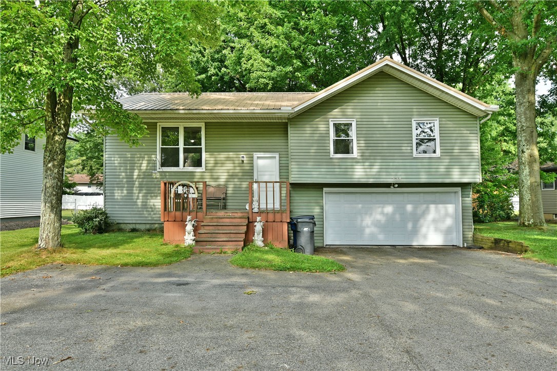 Take a look around this fresh-to-market Howland bi-level and see why it’s so easy to call it “home!” The desirable location puts you moments away from local attractions and schools alike while the deep-set property offers up an expansive backyard, fenced-in with great views and a large storage shed. A handsome, green-colored exterior quickly sets the home apart from its peers, welcoming you in with its raised, stained wood front porch. A tiled landing graces the foyer as stairs rise to find the main level. Here, dark colored hardwood style flooring spills throughout as sunshine cascades across the living room. Formal dining looks on with its own pair of windows, offering great views of the backyard. An elegant kitchen includes cherry-colored cabinets and tasteful splashes of brightwork with its stainless accents and appliances. Down the main hall, a tastefully appointed full bath joins in with tiled flooring. The trio of spacious bedrooms follow suit, providing ample living space that increases in size to the largest, master bedroom. Inside, dual closets join a full private bath with a sleek vanity. At the basement level, an additional half bath brings the total to three. Ceramic tile flooring extends into the finished family areas and rec space. They are joined by hidden laundry services and a walk-out basement.