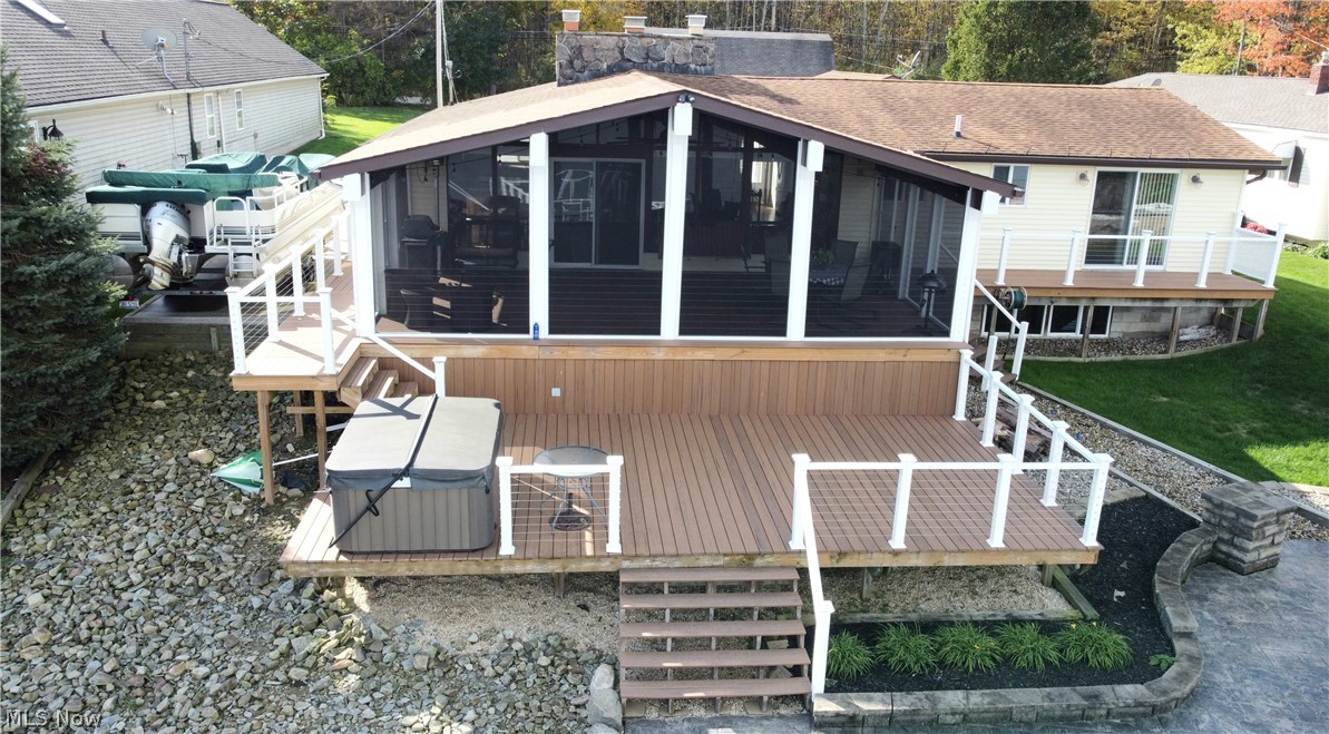 A most desirable Lakefront location with a large open view of the Lake & across to Sugar Creek. This home is just a few feet south of the Main Beach & Clubhouse grounds where you find the Pool, Tennis & Pickle Ball & Volley ball courts. Kids playground & covered picnic Pavilions. You're close-by for all of the seasonal activities; cardboard boat race, Polar Bear plunge, Clam bake & fishing events. Also near the Greenway Trail. Enjoy the many boating activities, also including the view across to Beach II swimming area & the July 4th Fireworks, all from the multi level decks, stamped concrete patios, (even out over the boathouse) to sitting around the 17ft diameter Firepit. See the Stars or rising Moon from the elevated Hot-tub on a cool evening. All these ways to enjoy the lake and you'll be able to keep the lake toys at the water's edge in the boathouse. In addition, there is the 400 sq.ft. Barn w/ 12' high Door to store multiple vehicles from 4x4's to boats or other equipment. There