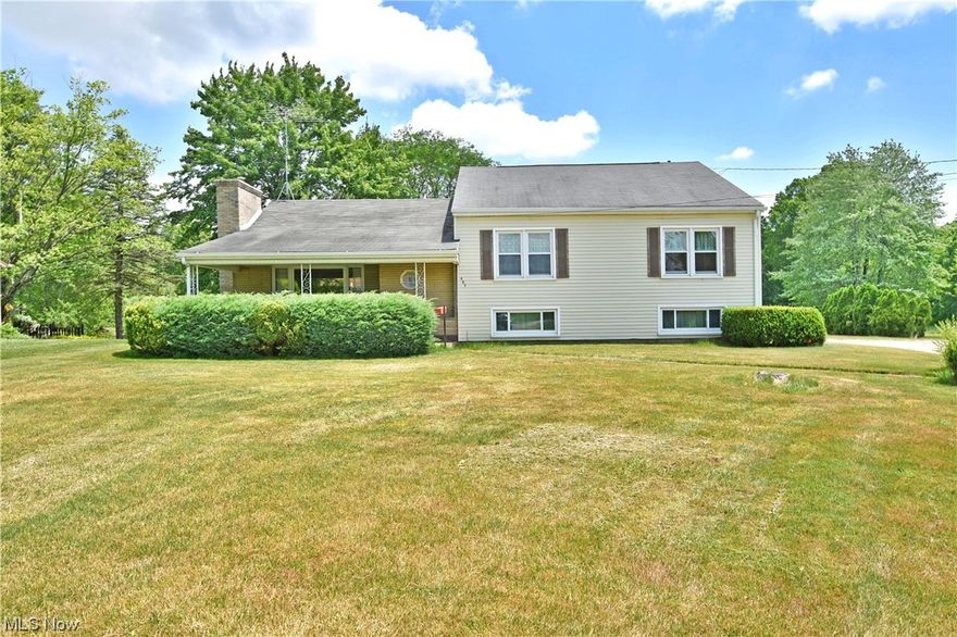 Don’t miss your opportunity to be first through the door of this prominent Vienna residence, boasting an expansive lot (1.98 acres) with an equally impressive outbuilding! A winding blacktop drive leads up to the home as concrete apron extends towards the additional garage space with oversized entry doors. A third, single car garage tucks away under the side of the home, quickly tying into the nearby sunroom. A covered front patio hides in the privacy of tall landscaping as the decorative front door opens to find an endearing living room. Here, carpeted flooring joins a brick lined fireplace as the gracious picture window fills the area with natural light. A stone divider encloses the main stairway while a central dining room enjoys built in hand made cabinetry and unique overhead lighting. The tile lined kitchen follows with its faux brick backsplash and bold, red countertops. Around the corner, a sun filled breakfast room takes full advantage of the backyard views. At the upper level