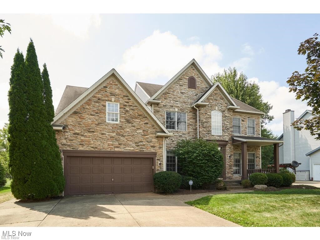 Wonderful 2 story home located in Kingsbury Trace with over 3200 sq ft on the fist floor and 1000 plus sq ft finished in the lower level.This home has excellent open floor plan beginning with the 2 story wood floor foyer. The living room is to the right of the foyer and also has hardwood floors. The dining room is opposite side of the foyer with hardwood floors. The back of the house offers a massive Great room with soaring ceilings and 2 stories of southern exposed windows to enjoy all the natural light that flows through this entire house. A gourmet size kitchen with oak cabinets and floors has been updated with granite counter tops and tiled back splash. The kitchen offers an island, pantry closet and a sliding glass door in the eating area that leads to a private deck and large back yard with a pond view. There also is a first floor den with tile floor, crown molding and a large picture window to enjoy the back yard views too.Tucked behind the kitchen is first floor laundry with exterior door to the deck.The open staircase with wood treads leads to the upstairs with 4 spacious bedrooms.The upstairs hall also has wood floors and is an open cat walk viewing the Great Room.The master has double doors from the hall , a walk in closet and large master bath with oak cabinets and updated granite counter tops and sinks. There are 3 additional bedrooms with ample closet space and the main bath has also been remodeled. The lower level has an additional 1000 plus sq feet finished with a rec room with a built in wet bar, an additional office and another full bath.The front of the house has been refaced with stone and has a wonderful covered front porch. Just move in and make this home your. The family will love the amenities offered at Kingsbury Trace with the pool, clubhouse, tennis courts, playground and walking trails. What a great location close to schools, shopping, highways and in Copley Fairlawn Schools!