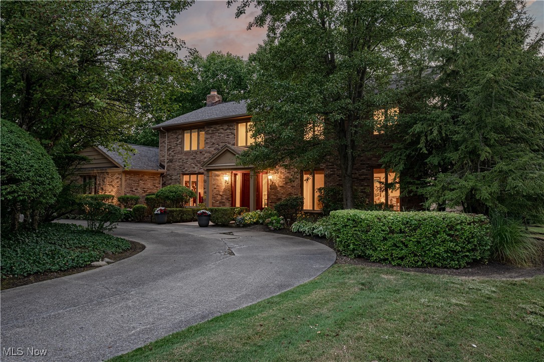 Set on a peaceful cul-de-sac in one of Pepper Pike’s most desirable neighborhoods, a circular driveway framed by mature trees leads to a gracious front entrance, where timeless design and thoughtful updates blend to create a home of warmth and sophistication. Inside, a two-story foyer with hardwood floors and a sweeping staircase sets the tone for timeless elegance. Formal living and dining rooms extend gracefully from the foyer, offering refined spaces for entertaining or intimate gatherings alike. The updated kitchen boasts granite countertops, rich custom cabinetry, a striking stone backsplash, double oven and warmer, two dishwashers, two sinks, plus a wine fridge. A large center island with breakfast bar seating and a sun-filled eat-in area create the perfect setting for everyday living. Sliding doors open to a deck with peaceful wooded views—perfect for morning coffee. The adjoining family room is both impressive and inviting, featuring a fireplace, custom built-ins, and walls of windows that flood the space with natural light. A handsome office with built-ins provides a private retreat, while a flexible first-floor bedroom suite, complete with an adjacent full bath, offers versatility for guests or the option of a main-level primary suite. A convenient half bath is thoughtfully placed near the office and kitchen. Upstairs, the luxurious primary suite boasts a spacious bedroom, walk-in closet, and spa-inspired bath designed for relaxation. Three additional bedrooms share a generously sized full bath, providing comfort and style for family and guests alike. The partially finished lower level extends the living space with a versatile recreation room, a bonus room, and ample storage. Outdoors, the backyard feels like a private sanctuary with tree-lined views and expansive green space that invites both quiet reflection and lively gatherings. This Pepper Pike gem offers a rare opportunity to call one of the community’s most distinguished homes your own.