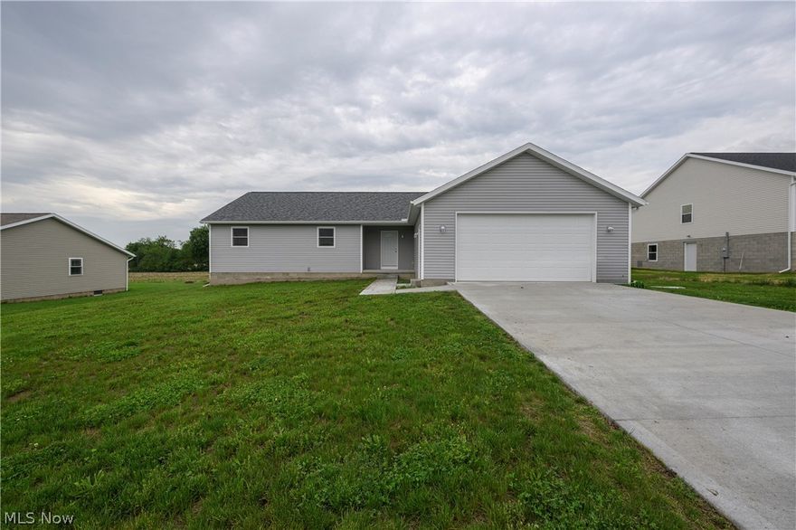 Why wait through the stress and delays of construction when you can move right into this pristine, open-concept ranch home built in 2025? Situated on a beautiful lot overlooking picturesque farmfields, this property offers a front-row seat to breathtaking evening sunsets right from your own backyard. Designed with modern entertaining in mind, the heart of the home features a seamless flow between the spacious living, dining, and kitchen areas. The kitchen comes fully equipped with all appliances to stay for the new owner, making your transition effortless. Just off the main living space, a rear deck steps down to a perfectly flat yard, creating an ideal setting for summer barbecues, outdoor games, or simply relaxing as the sun goes down. A private primary suite, complete with its own dedicated ensuite bathroom for a true retreat, makes the layout ideal. Two additional bedrooms and a second full bath offer plenty of space for family or guests. Convenience is key with a dedicated first-floor laundry room. Spacious two-car attached garage. If you need room to grow, the massive, unfinished basement serves as a blank canvas ready to be transformed into a home gym, recreation room, or extra storage. Immediate possession available. Tusky Valley Schools. Skip the building process and start enjoying the peaceful country views today!