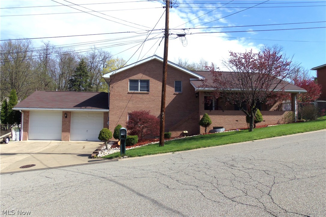 MINUTES TO RT 22... is this spacious 4 BR, 22 year young brick home situated on 2 lots on Weirton Heights. Large, fully equipped open kitchen with dining room and island. Rec Rm with fireplace and bath offers a 4th BR or office, perfect as in in-law suite. Oversized 2 car attached garage, above ground pool with decking and covered patio.