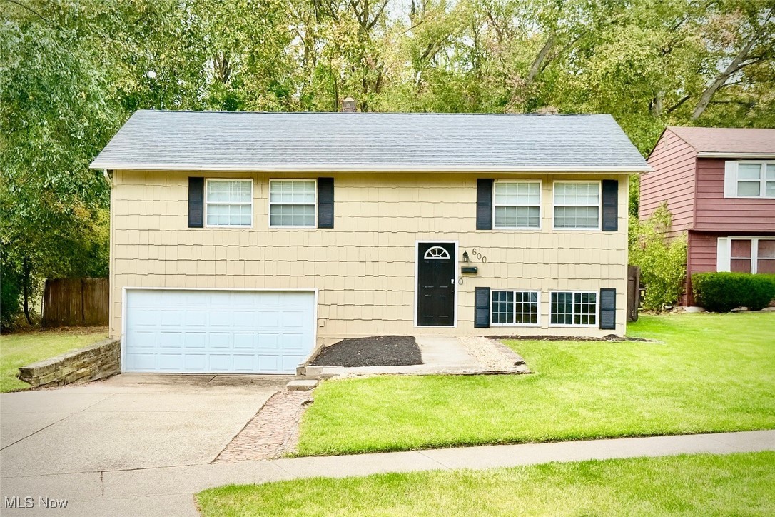 Welcome to 600 Silver Meadows Boulevard - a well-maintained and move-in ready 3-bedroom, 2-bathroom bi-level home located in the Kent City School District. This inviting property features fresh interior paint and brand-new flooring throughout, with original hardwood floors in two of the bedrooms, adding warmth and charm. Large windows fill the home with natural light, creating a bright and open feel in every room. Outside, you'll find fresh landscaping that enhances the home's curb appeal, along with a spacious back deck, perfect for entertaining, relaxing, or enjoying the peaceful outdoor setting. The lower level offers additional flexible living space ideal for a family room, home office, or gym. Conveniently located just minutes from Kent State University, local parks, shopping, dining, and public transportation. Don't miss your chance to own this beautifully updated home-schedule your showing today!