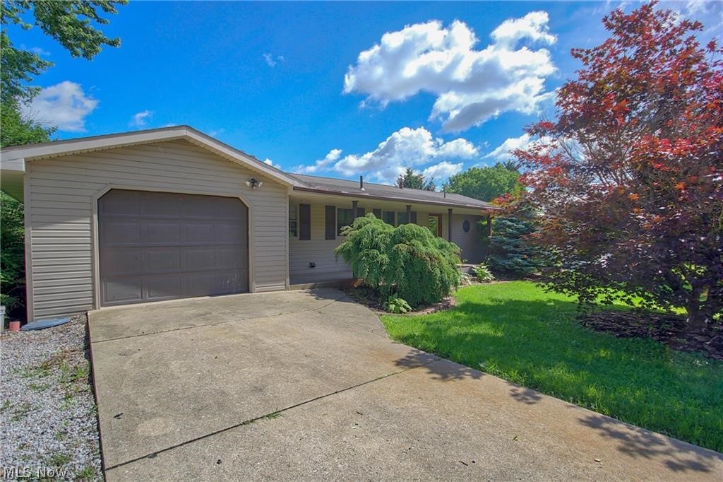Welcome to 104 West 1st street! This sprawling ranch is situated on .3 acres within the Minerva local school district. From the moment you walk in the door you will feel right at home! The foyer greets you with beautiful hardwood floors and sightlines into the spacious living area an eat-in kitchen. The living area features French doors that fill the room with tons of natural light and lead onto the double staircase deck, perfect for entertaining! The kitchen offers an ample amount of counterspace, perfect for prepping meals. This room also boasts new flooring that flows into the first floor laundry/mudroom and gives access to the main floor attached garage! Down the hall you will find two great sized spare rooms refreshed with new carpet as well as an updated full bath. The master suite is complete with a large closet and half bath. Downstairs the walk out basement has been transformed into a spacious living area with two spare rooms, a kitchenette, along with a full bathroom, an acce