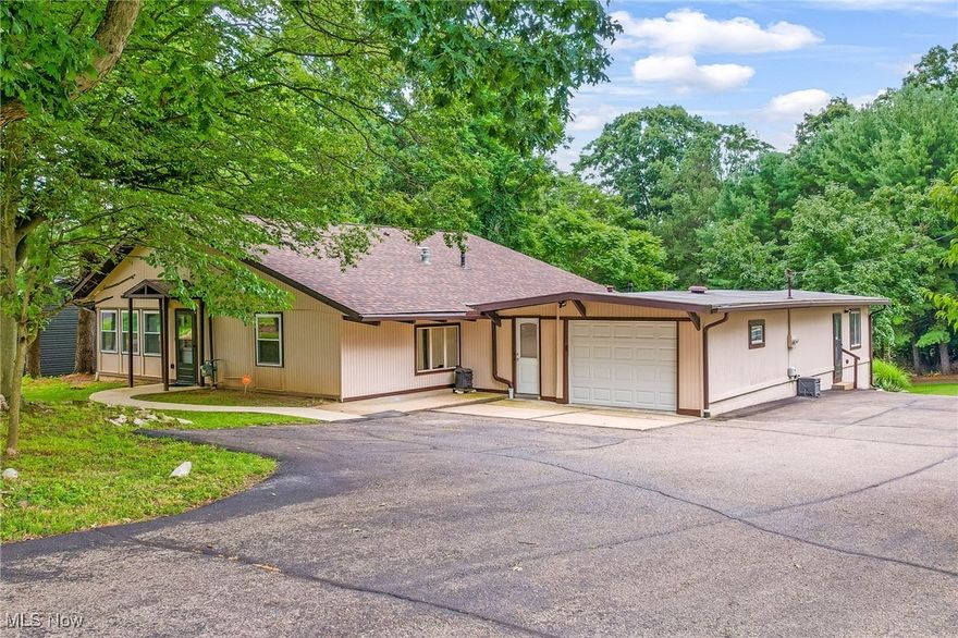 Located adjacent to Zanesville’s Art Museum, this modern single-story home boasts 4 bedrooms, 3 full bathrooms, and over 2,000 square feet of living space that’s sure to impress. The cathedral-style beamed ceilings amplify the spacious feel throughout, while a large wooded lot with a circular driveway highlights the natural surroundings. Inside, you'll find a bright family den flooded with natural light and a welcoming back deck perfect for relaxing. The primary bedroom features its own private bathroom complete with a jacuzzi tub. Additionally, there's a 10 x 16 storage shed for outdoor essentials and an attached, climate-controlled garage for year-round convenience.