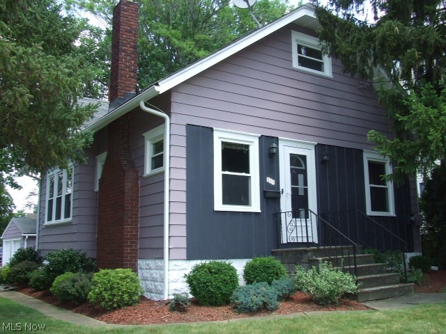 Cute well-maintained Bungalow with formal, fireplaced living room with built-in bookcases, hardwood floor and wide baseboards, formal dining room with long window seat, updated, applianced kitchen, and small, enclosed backporch/mud room. Full bathroom with deep tub and two bedrooms complete first floor, one bedroom does not have closet but stairs to 2nd floor bedroom (County lists it as 3 bedrooms). Front bedroom has new carpet. Upstairs bedroom has couple closets and two skylights. There's a 3-level deck leading to detached 2-car garage with opener and 220. Exterior of house and garage just painted, glass block in basement windows, newer windows, furnace 2013, 220 electric. Make your appointment today to see this cutie!! Home Warranty included.