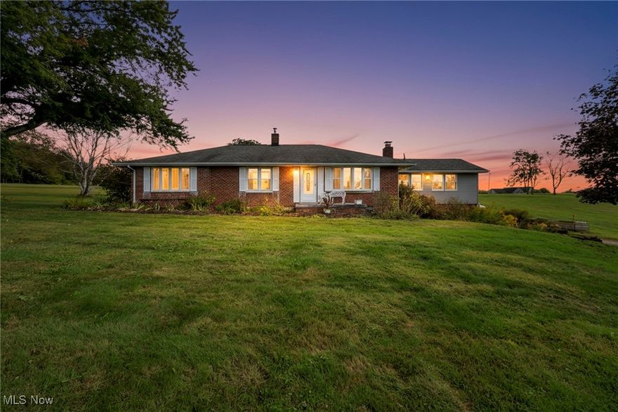 Welcome to 10294 Manor Road NE in Minerva, a property best suited for buyers seeking space, privacy, and exceptional outbuilding storage. Set on 3 open acres in the Minerva Local School District, this quiet, low-traffic setting offers a sense of privacy while remaining just minutes from downtown Minerva. A true standout is the 40x62 pole barn, featuring a concrete floor, oil heat (garage only), electricity, water access, automatic garage door openers, a man door, and a vehicle pit — ideal for a workshop, storage, or recreational use. The home offers 4 bedrooms and 2 full baths with a flexible layout, including tandem-style bedrooms that provide versatility for home offices, guest space, or hobby rooms. The all-season sunroom, filled with natural light, overlooks the backyard and creates a calm space to relax year-round. Outdoor living is enhanced by a 300+ sq ft covered deck, perfect for enjoying the open surroundings. Additional features include a wood burner and a heat pump for heating and cooling. This property presents an opportunity for buyers who value acreage, usable outbuildings, and a peaceful setting — prioritizing function, space, and potential.